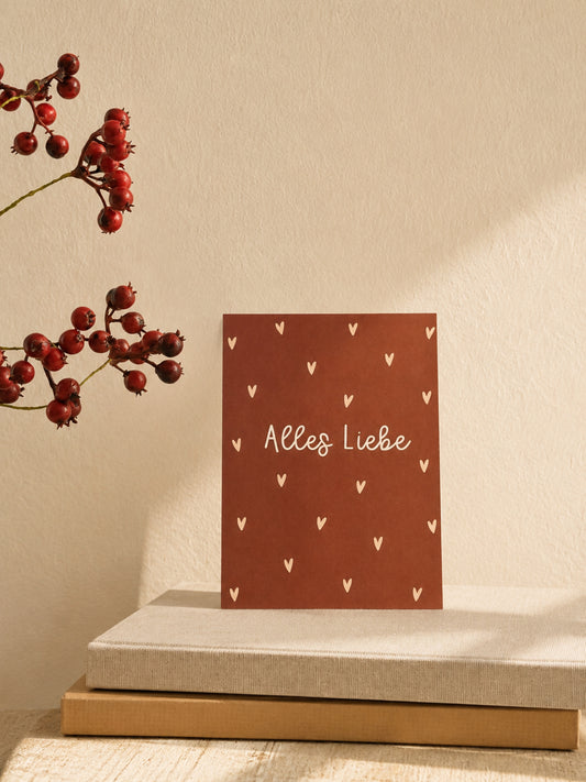 Postkarte "Alles Liebe" auf Büchern mit Zweig