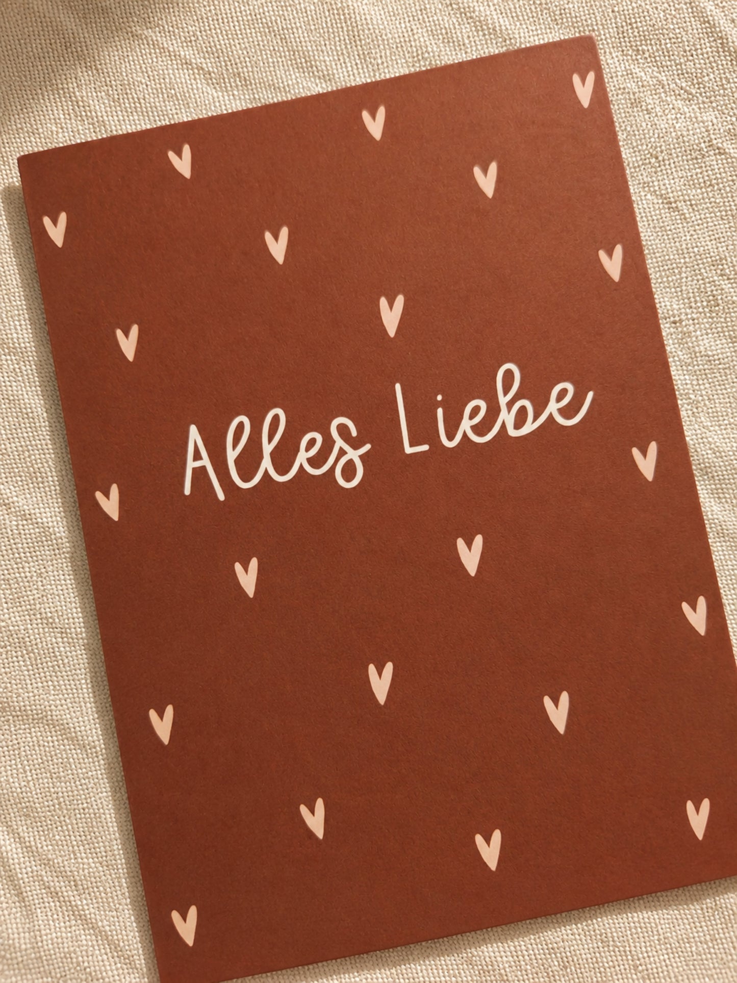Nahaufnahme der Postkarte "Alles Liebe" mit Herzmuster